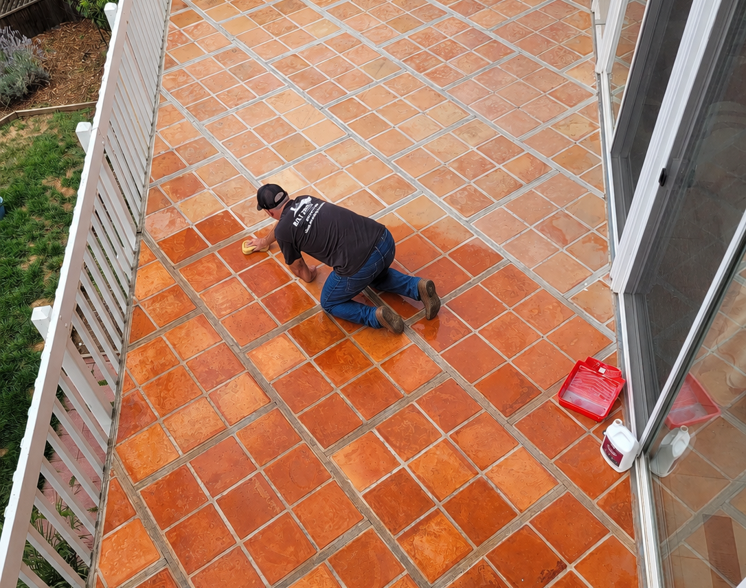 Bay Area Floors staff hand sealing outdoor patio tile